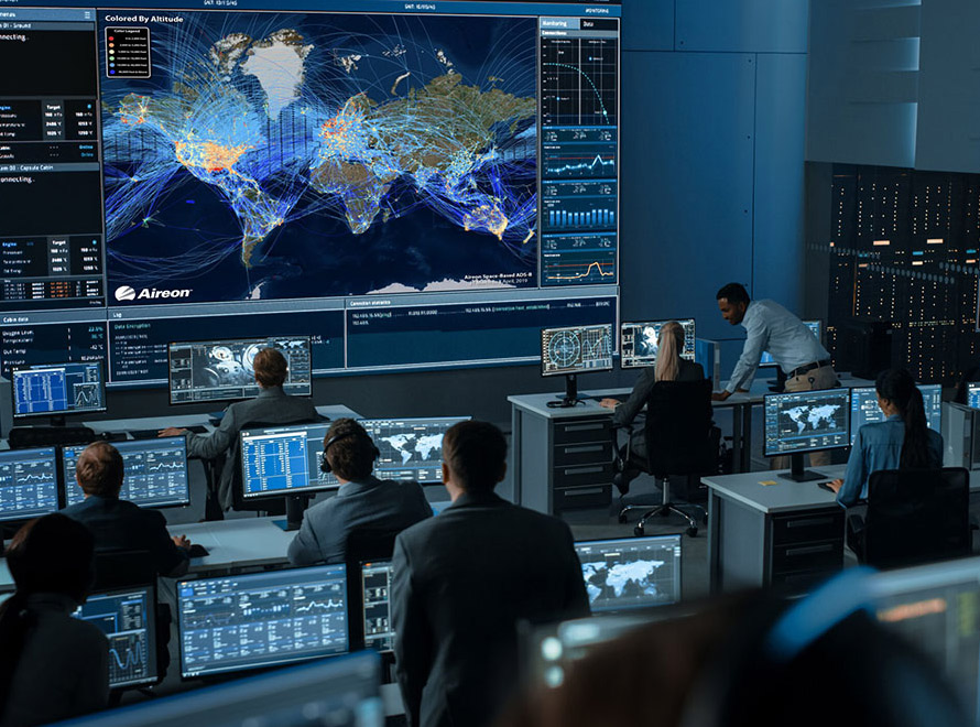 People at screens in a high-tech flight control centre