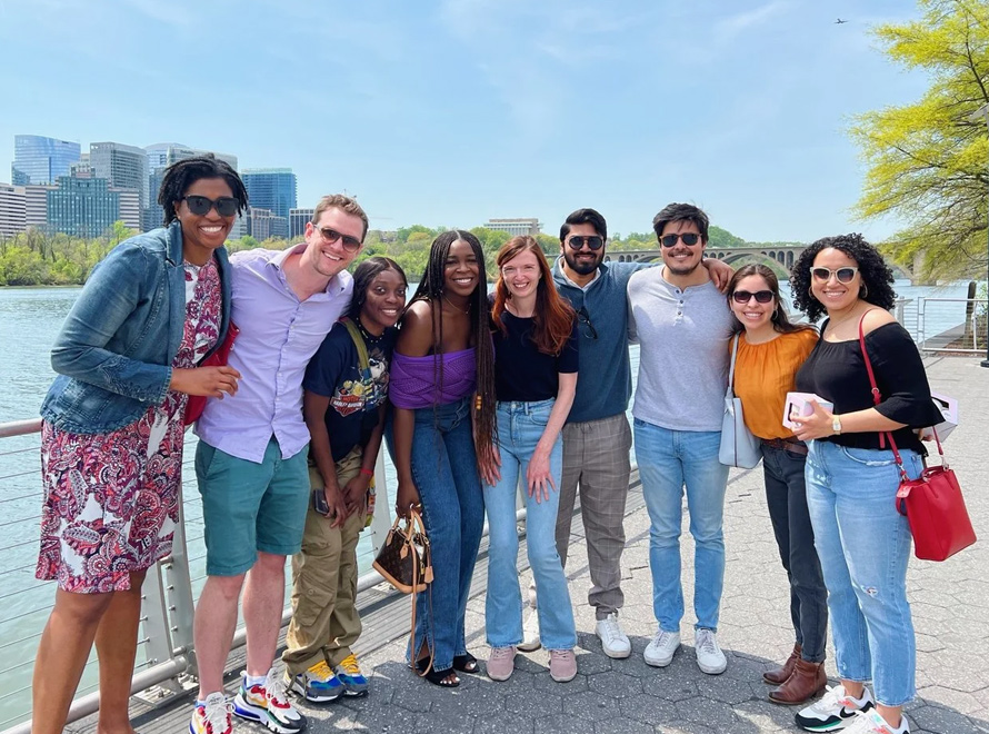 A group of colleagues standing by the water